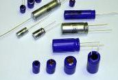 Assorted blue and silver cylindrical electronic components on a white surface