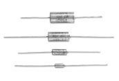 Four small axial resistors lined up horizontally on a white background