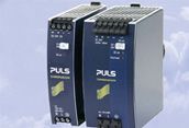 Two blue industrial power supplies standing side by side on a light background