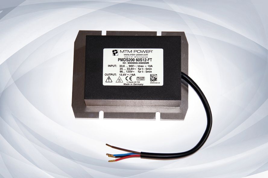 Black rectangular electrical transformer with exposed red, blue, and black wires on a light background