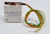 Small white electronic module with a brown top and bundled yellow-green wires attached.