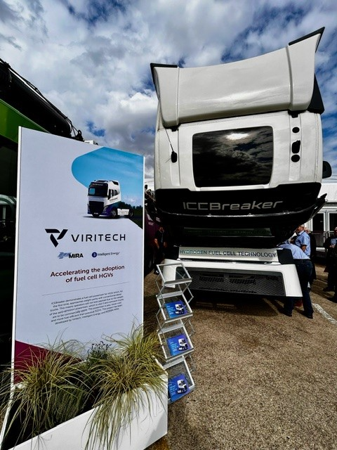 Viritech display beside white Icebreaker truck at outdoor expo, with blue brochure stand and cloudy sky