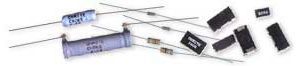 Assorted electronic components, including resistors, diodes, and black integrated circuits on a white background