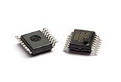 Two black integrated circuit chips on a white background, shown at slight angles.