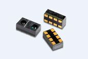 Three small black electronic sensors with yellow windows on a light background