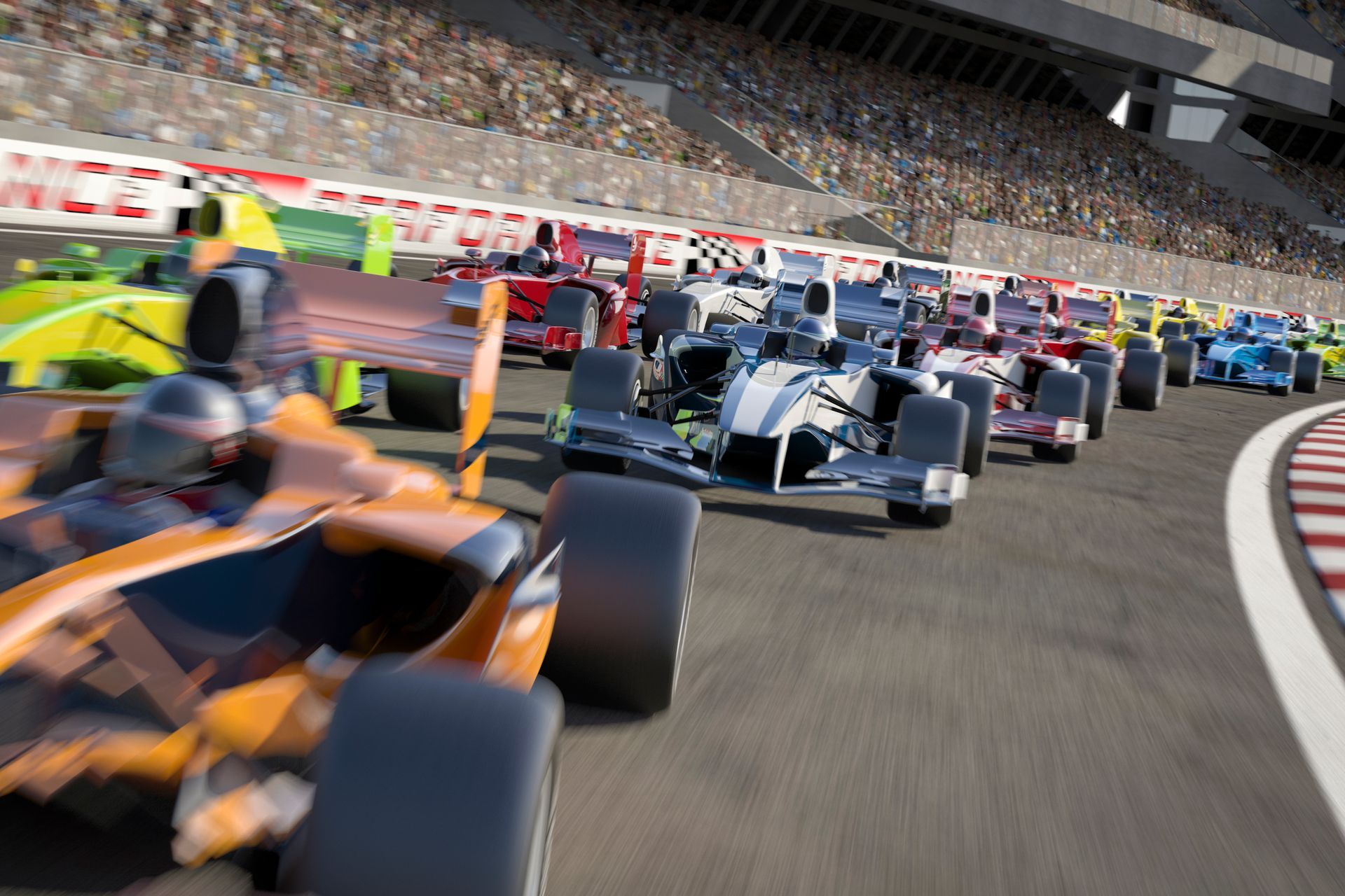 Formula racing cars speeding around a track, with an orange car in the foreground and a crowded grandstand beyond