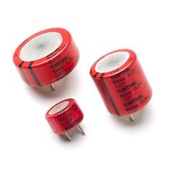 Three red electronic components with two metal pins each on a white background