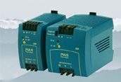 Two teal industrial control modules with front panels and vents, shown side by side on a light background