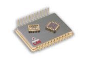 Close-up of a silver microchip with gold pins and two small integrated circuits on top