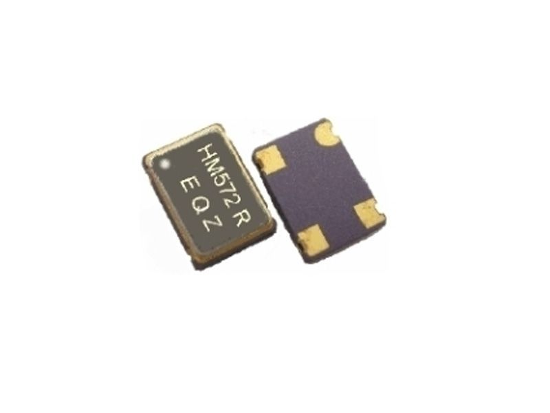 Two tiny black electronic chips with gold contacts on a white background
