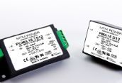 Two small white electronic modules with green connectors on a white background
