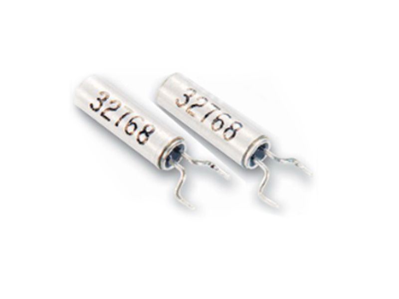 Two white cylindrical fuse components with silver leads on a white background