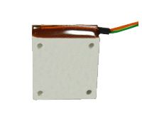 White square device with four corner screws and brown top, with red, green, and yellow wires attached