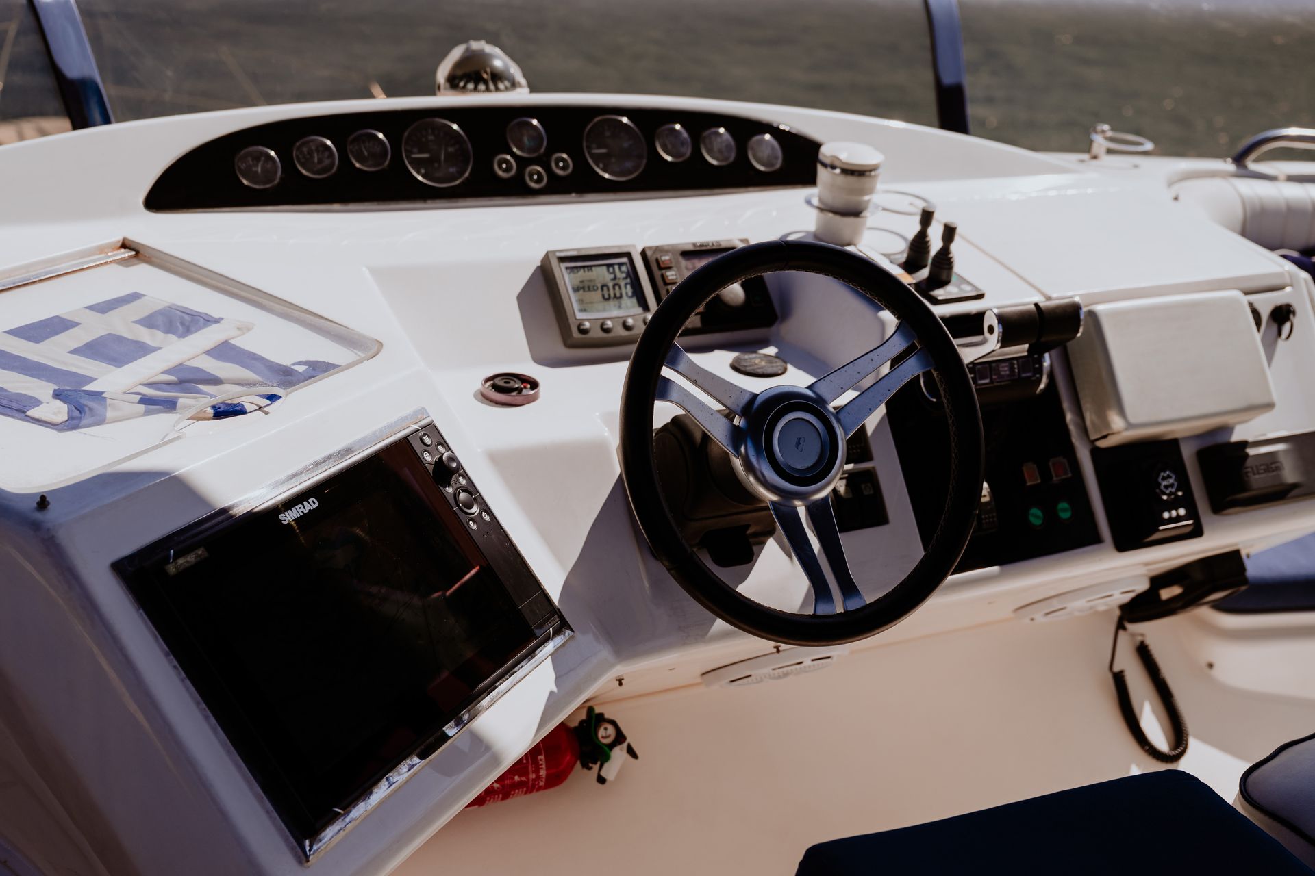 Yacht helm station with steering wheel and navigation controls