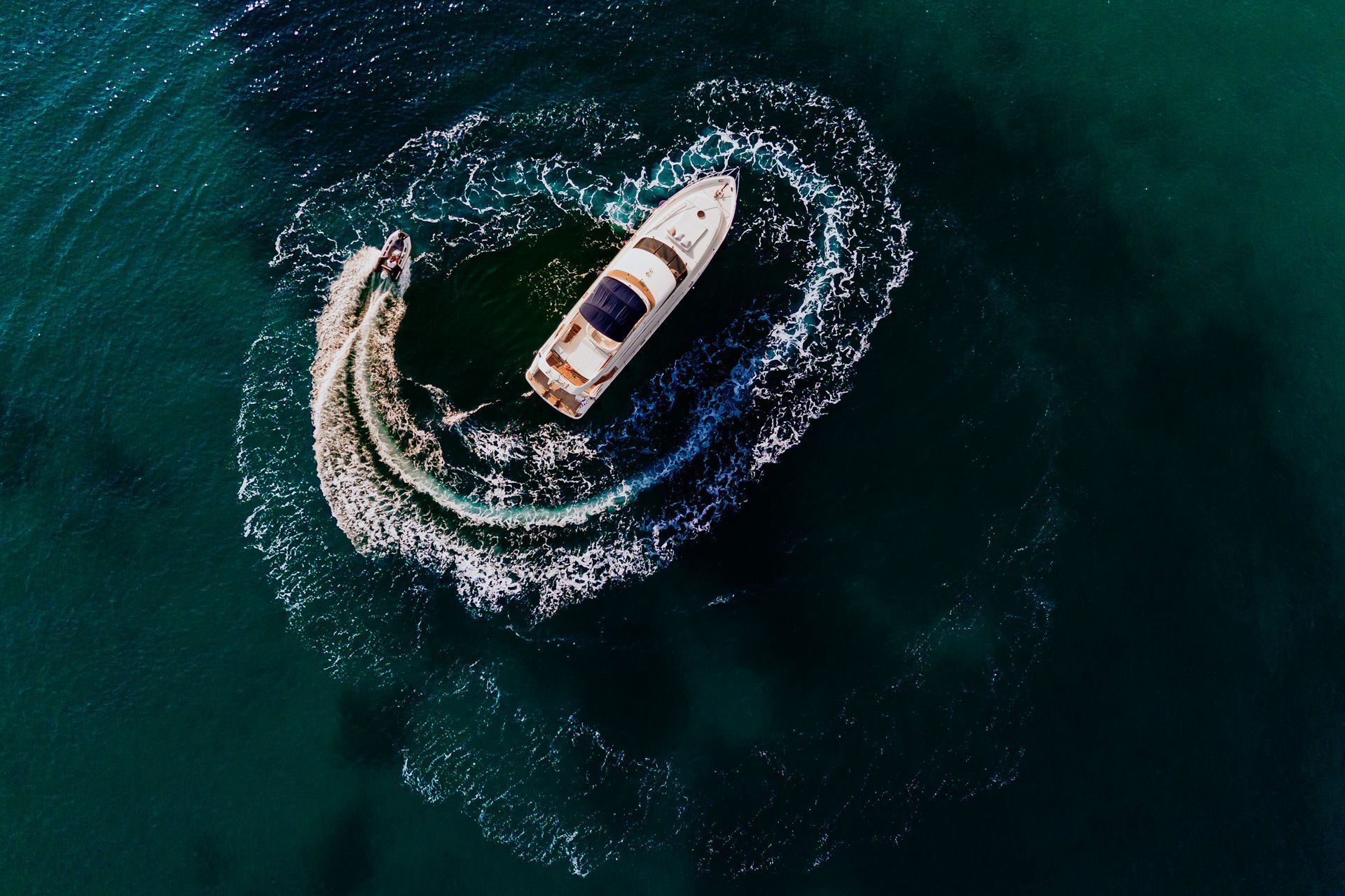 Aerial view of a yacht cruising through turquoise waters