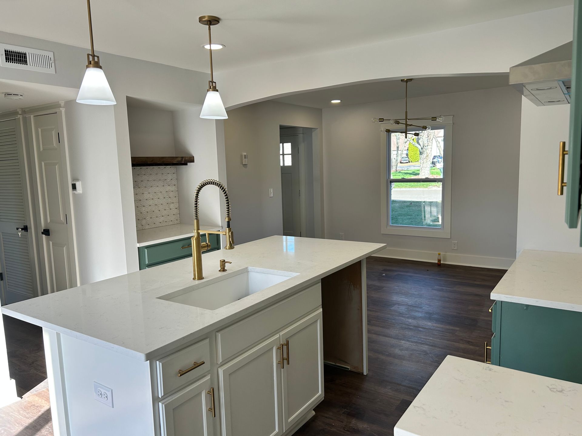 A kitchen with a large island and a sink.