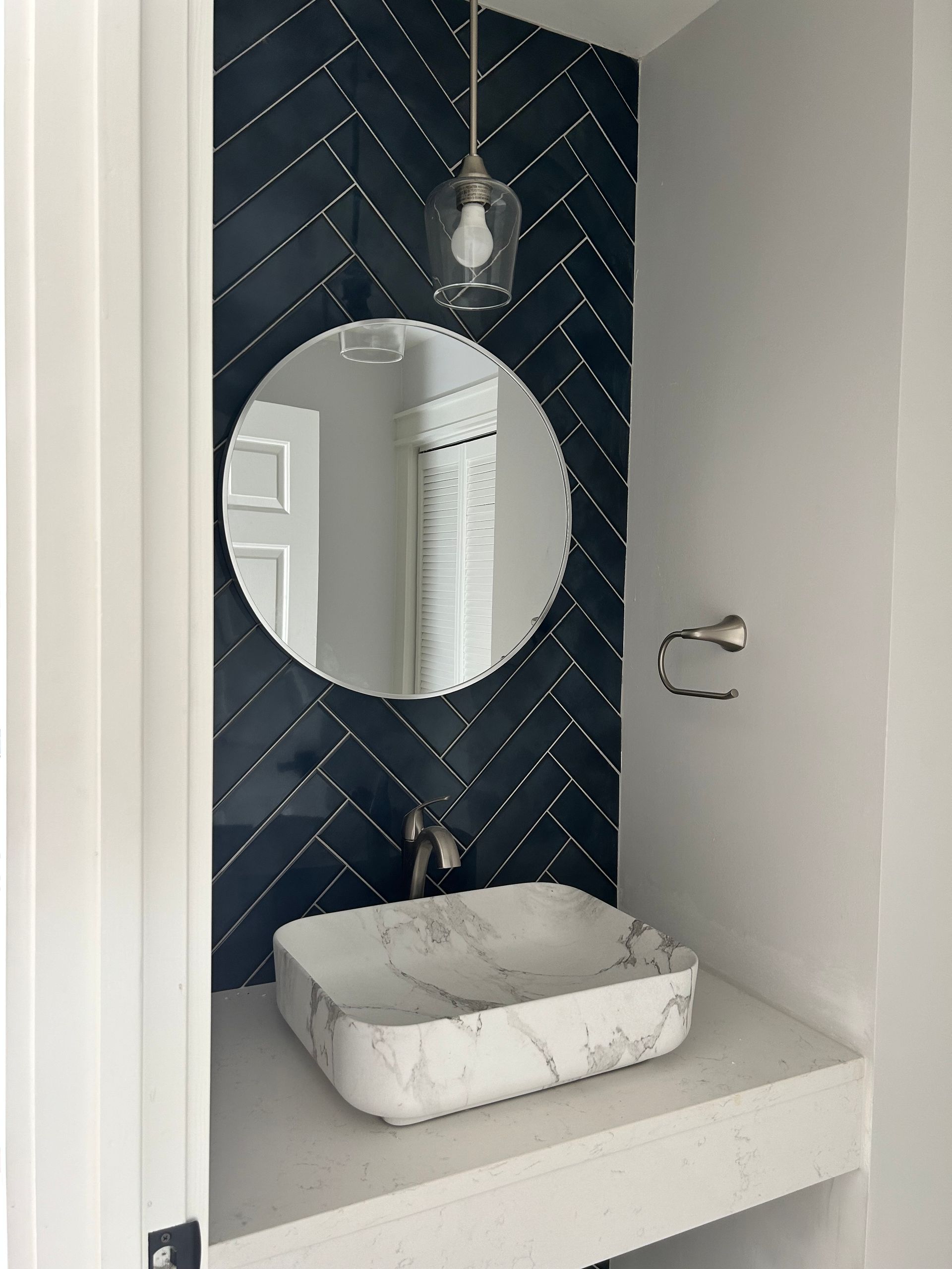 A bathroom with a sink and a mirror on the wall.