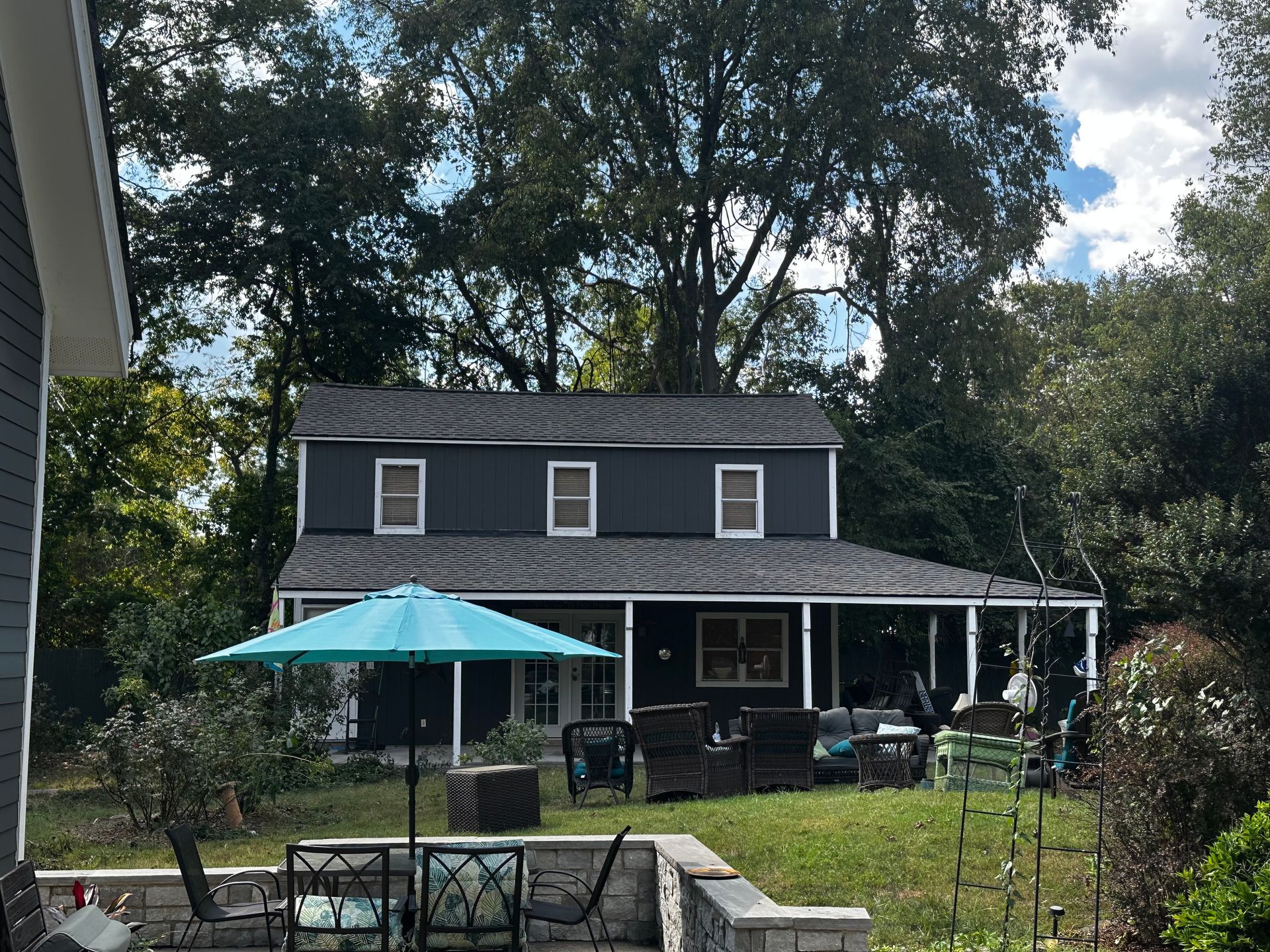 A house with a blue umbrella in front of it