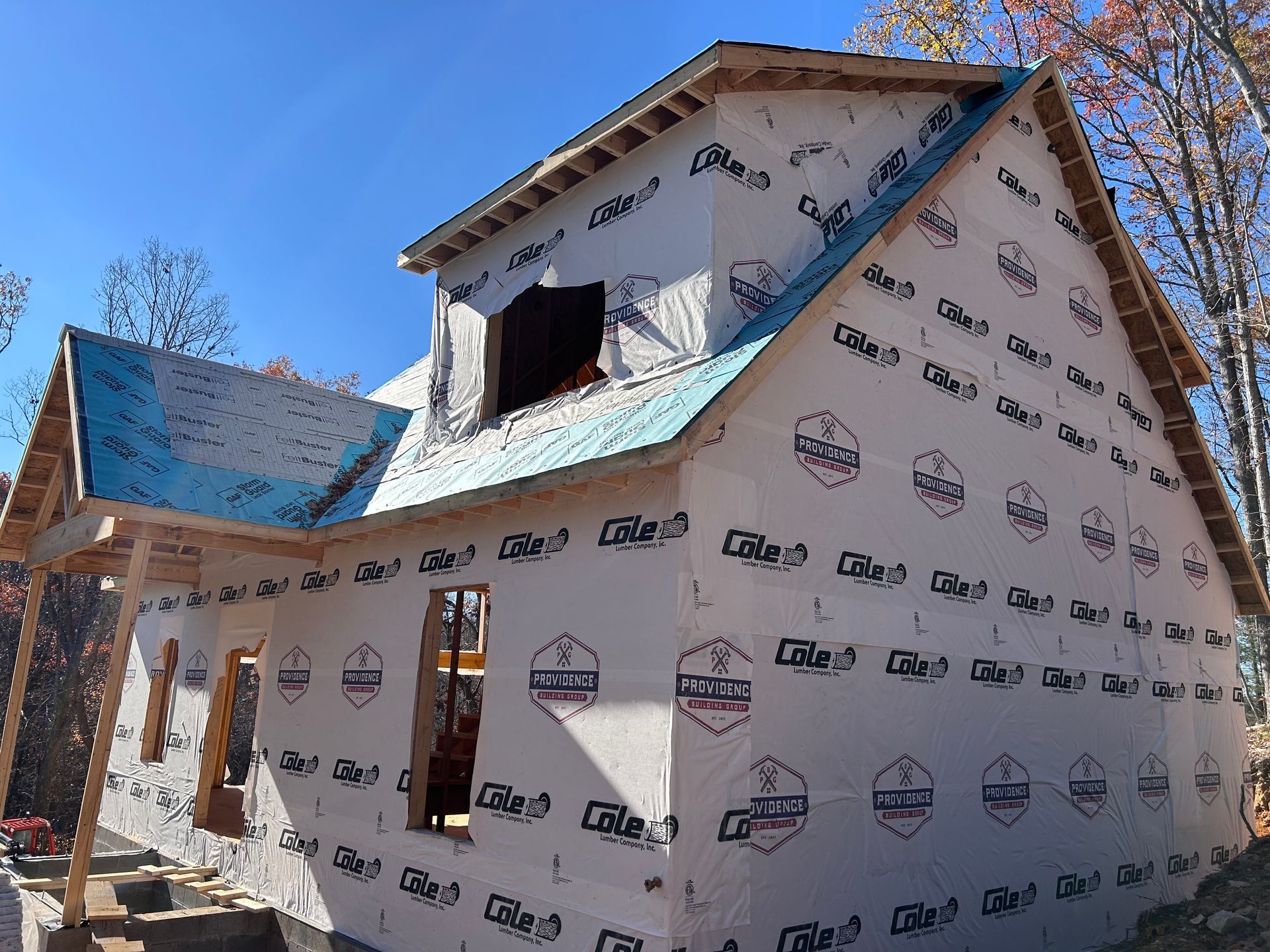 A house that is being built with a blue roof