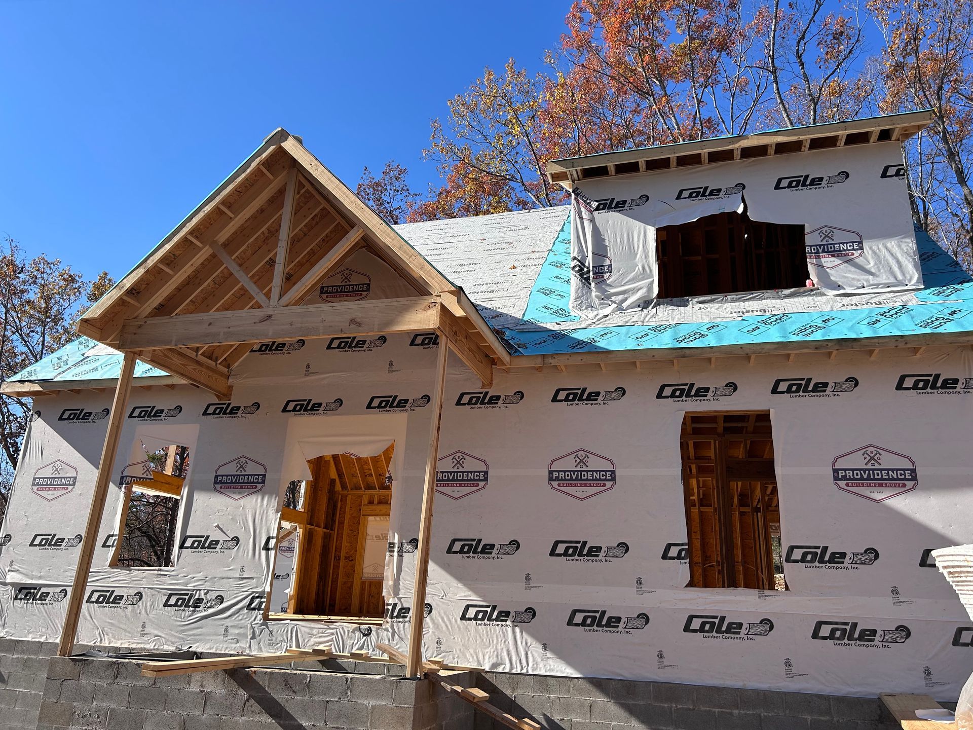 A house is being built with a porch and a roof.