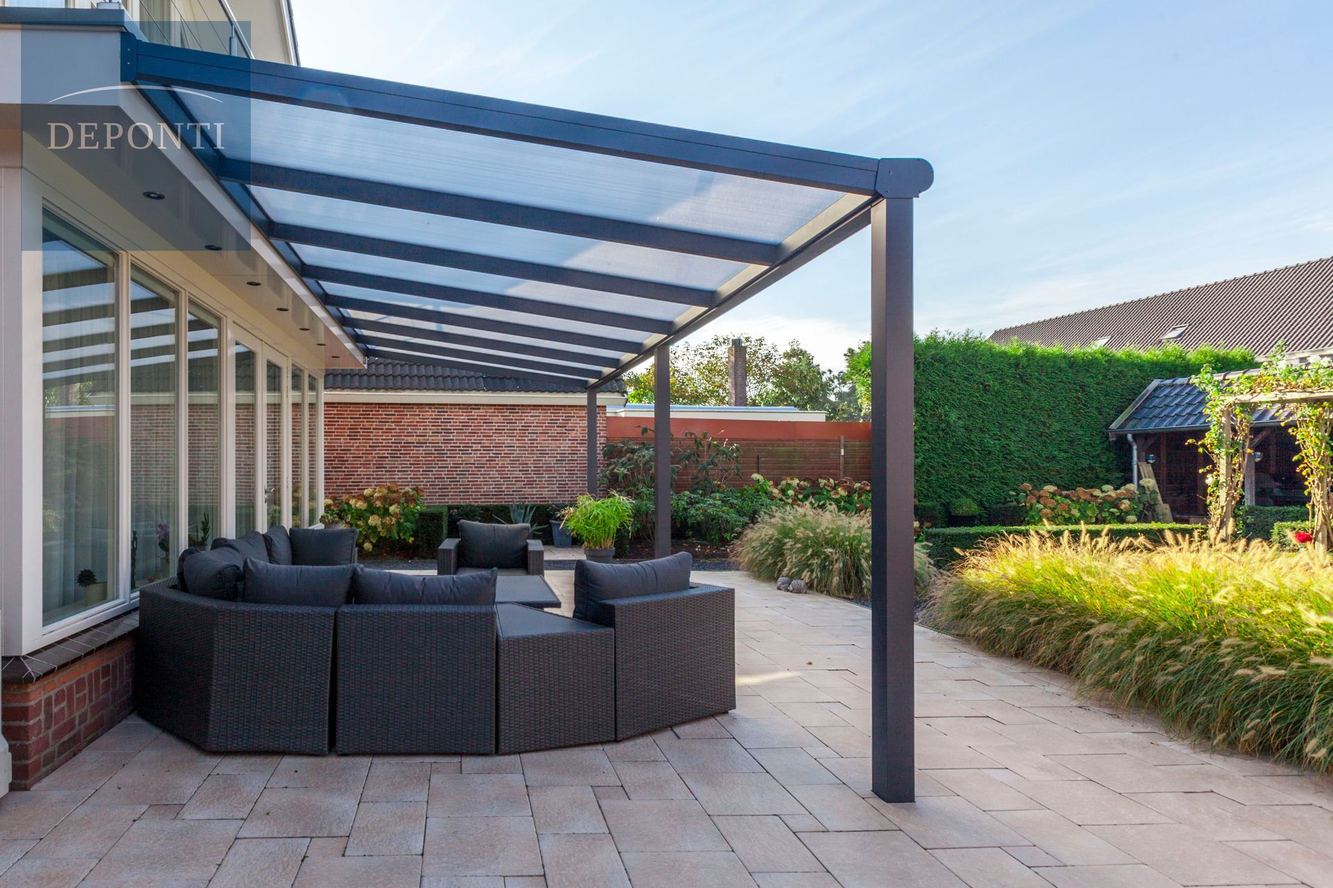a patio with a clear roof and a couch underneath it