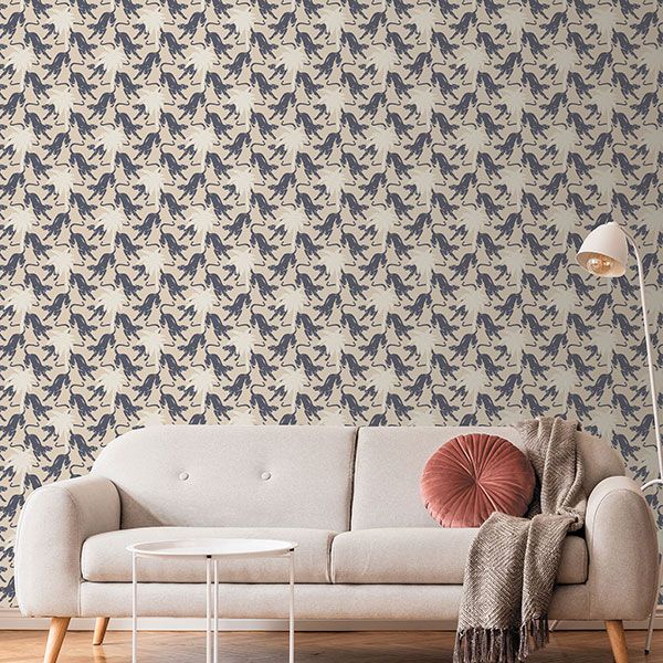a living room with a couch and a wall with horses on it
