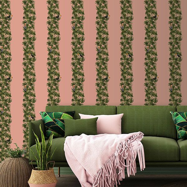 a living room with a green couch and a pink blanket
