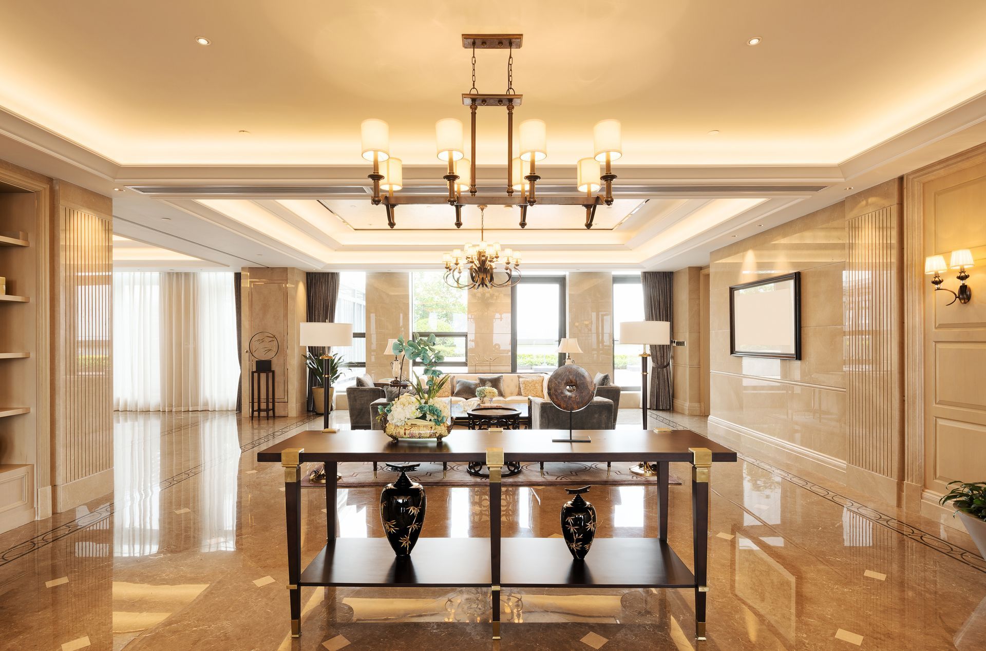 a living room with a chandelier hanging from the ceiling