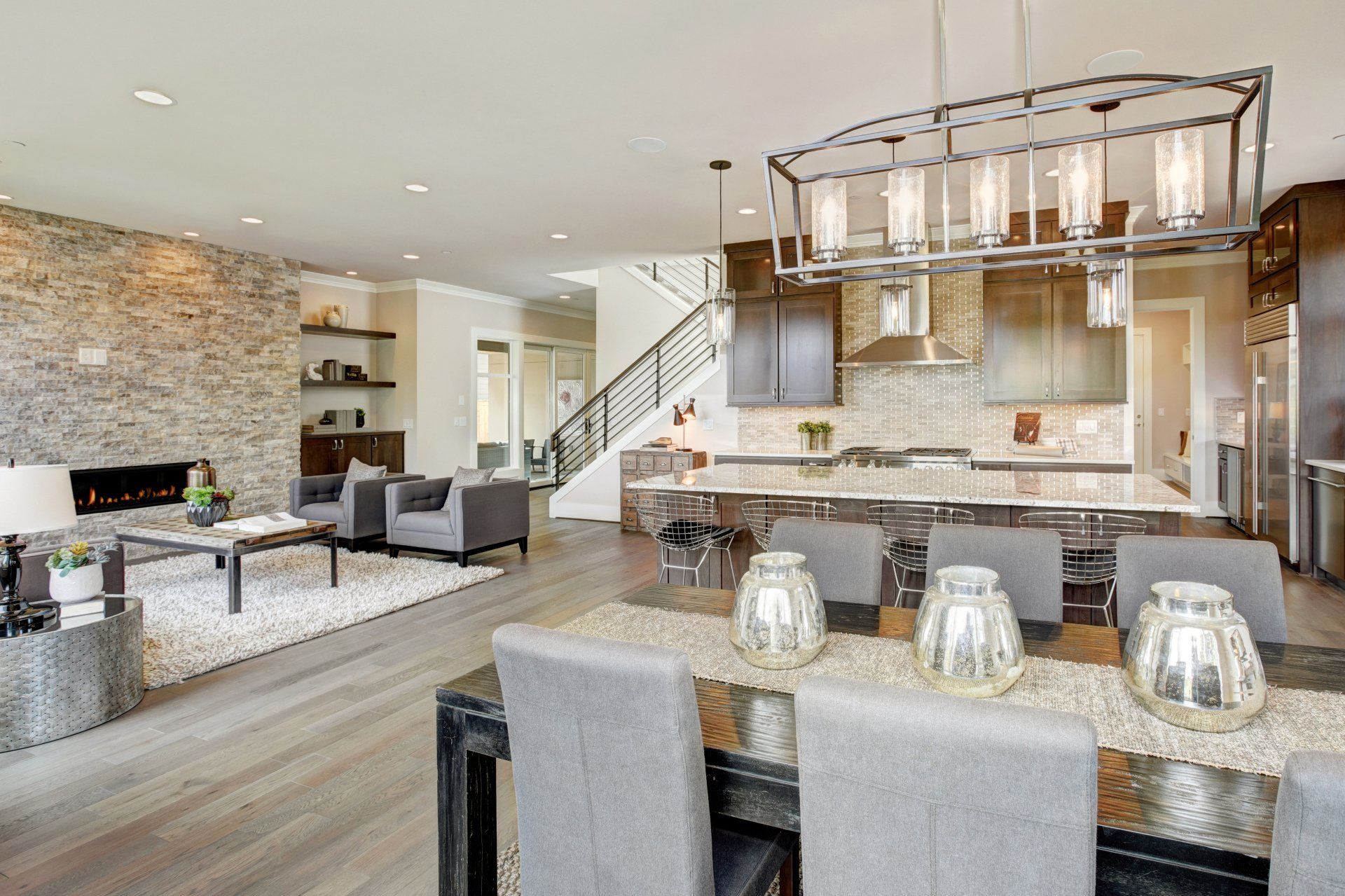 a living room with a dining room table and chairs