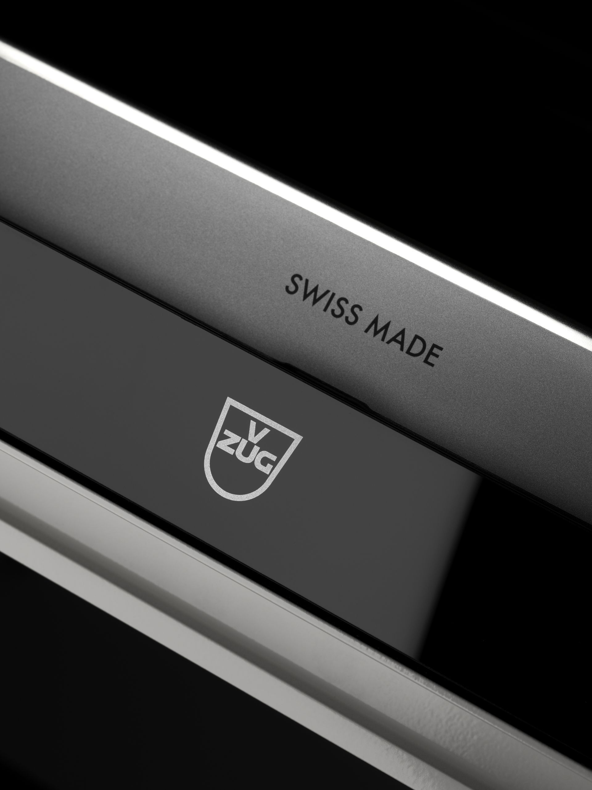 A close up of a swiss made appliance on a black background
