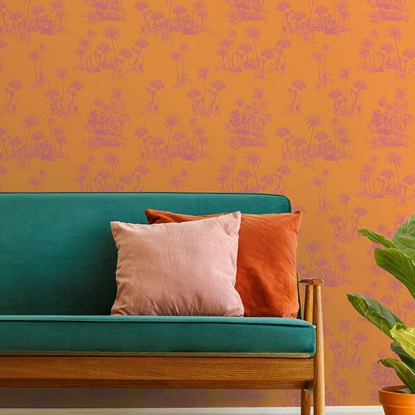 a living room with a blue couch and a potted plant