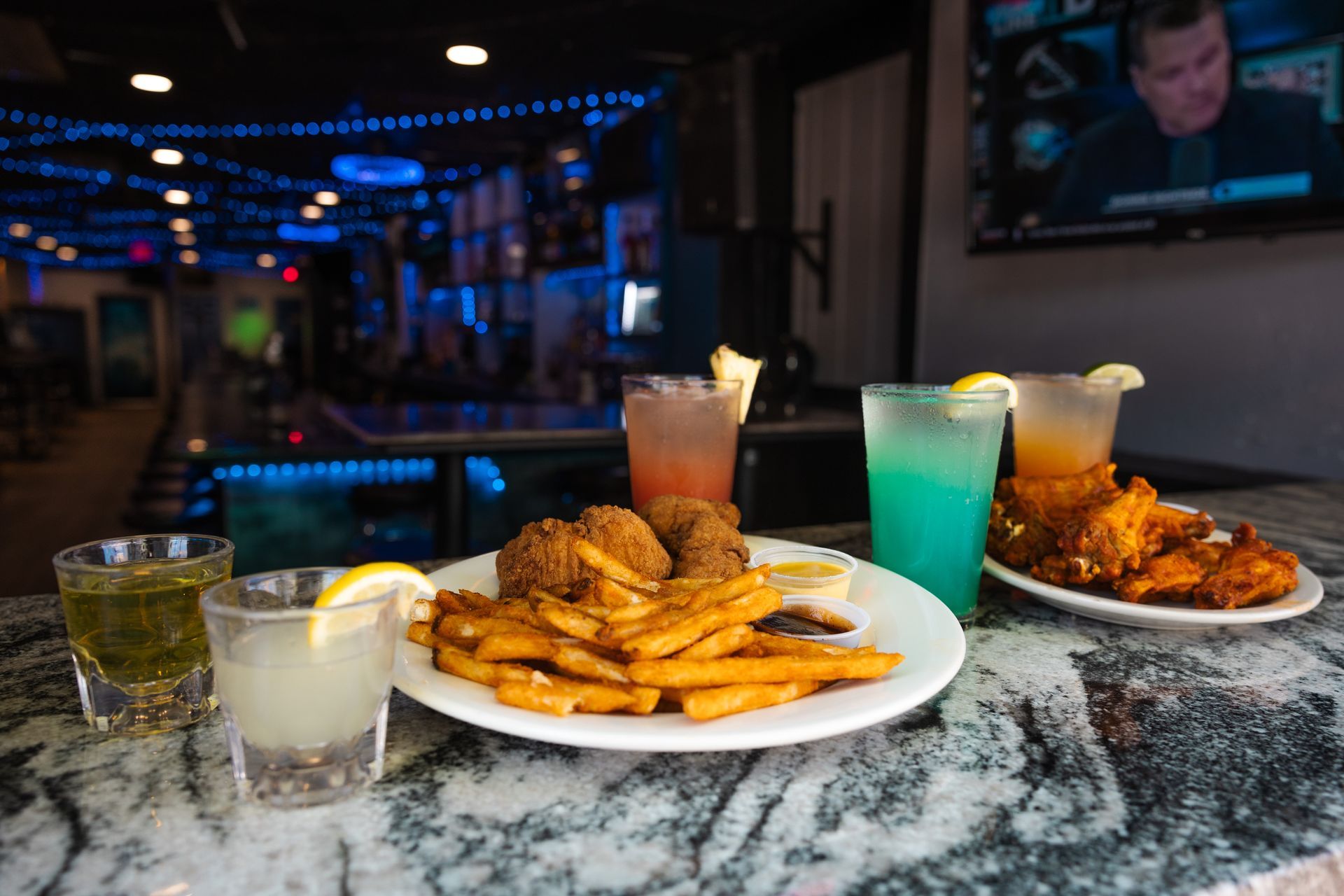 A table topped with plates of food and drinks.