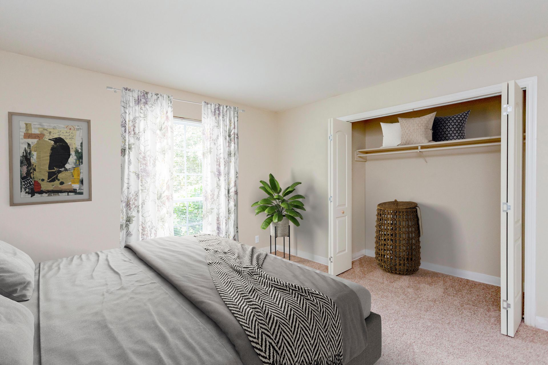 A bedroom with a gray bed, a window with sheer curtains, a potted plant, and an open closet with a hamper on carpet.