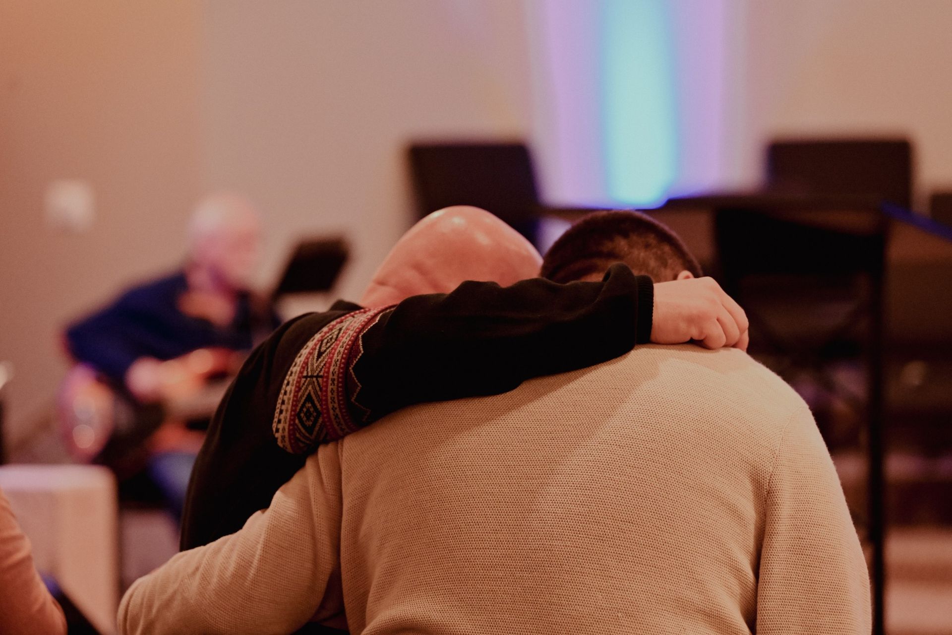 New Beginnings Church of God Pastor Scott Crowe praying with a church member