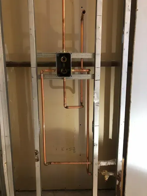 Copper pipe shower rough-in installation by 17 Plumbing during Oakville bathroom renovation