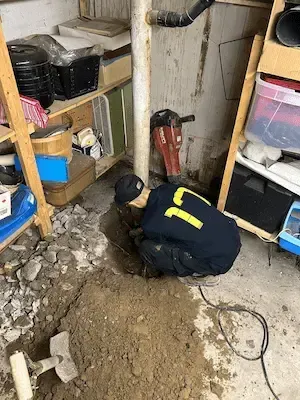 17 Plumbing licensed plumber performing underground drain pipe repair in Oakville basement