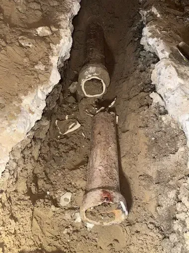 Emergency plumber Oakville repairing broken underground sewer pipe in basement