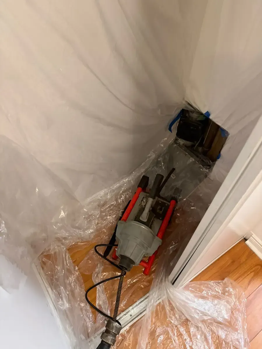 Emergency plumber Oakville clearing main drain backup in condo using professional drain machine