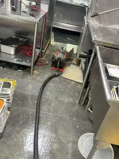 water spreading across floor from blocked drain commercial kitchen emergency plumber oakville