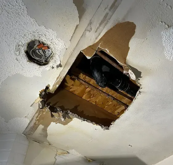 Licensed plumber Oakville opening wall to access damaged drain pipe and perform leak investigation and emergency repair