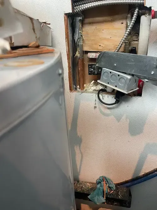 Exposed hot water pipes and insulation during leak investigation at Toronto Pearson Airport