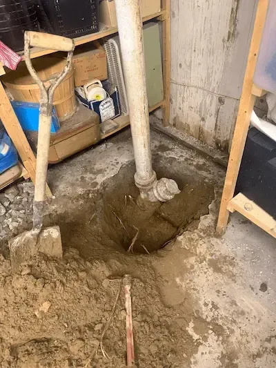 Underground drain pipe excavation in Oakville basement before pipe replacement — 17 Plumbing drain repair service