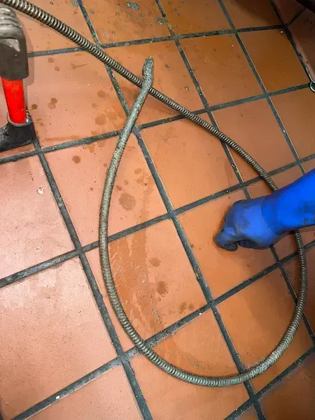 17 Plumbing technician performing emergency drain cleaning in Mississauga