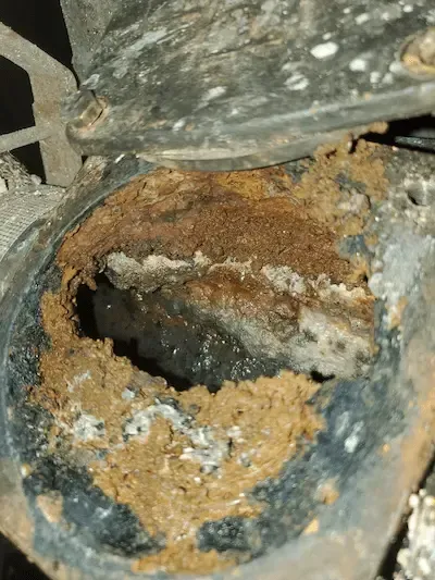 Severely corroded cast iron drain pipe interior with crack in Oakville home — sewer line repair by 17 Plumbing