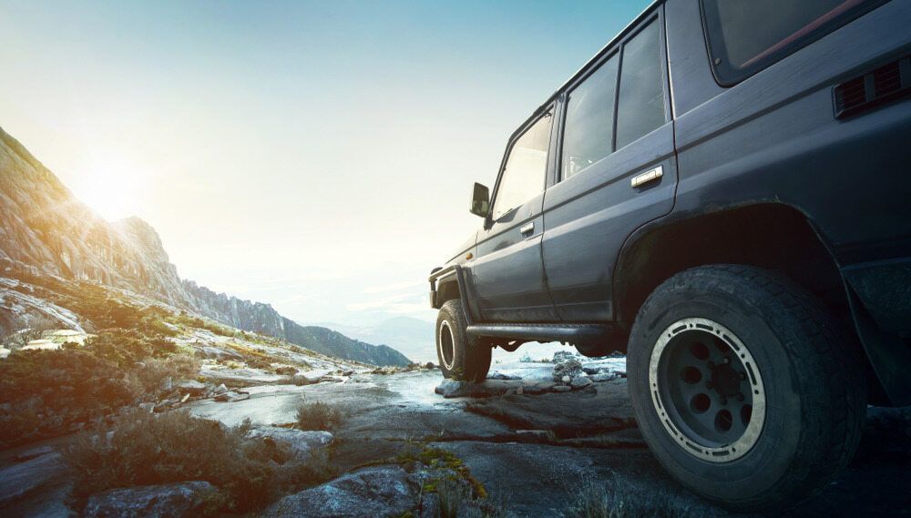A 4x4 Is Driving Down A Rocky Road In The Mountains — Loch’s Garage In Emerald, QLD