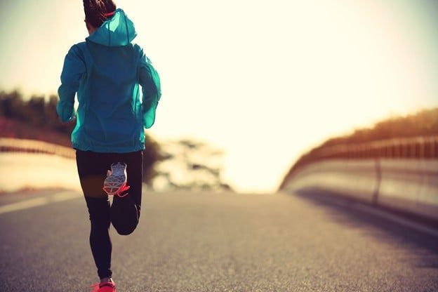 Woman in a Blue Jacket is Running Down a Road — Care FNQ Pty Ltd in Cairns City, QLD