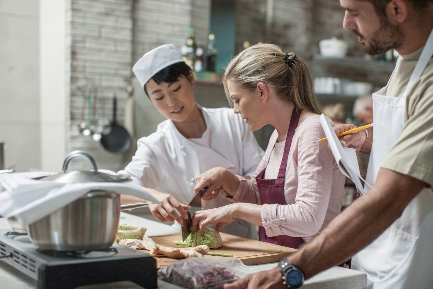 Group of People Are Cooking Together in a Kitchen — Care FNQ Pty Ltd in Cairns City, QLD