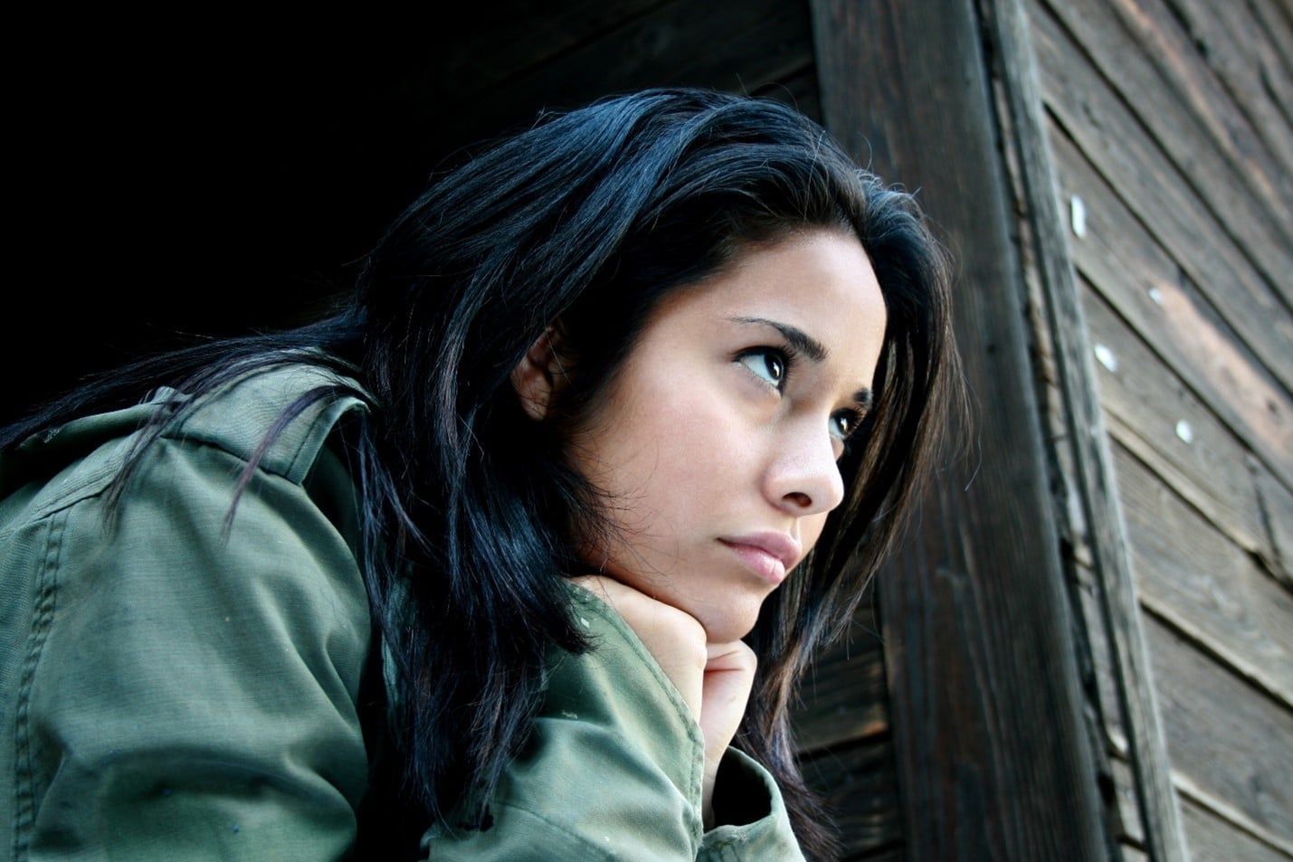 Woman in a Green Jacket is Looking Out of a Window — Care FNQ Pty Ltd in Atherton, QLD