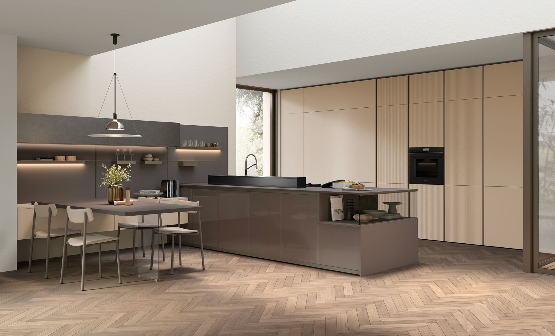 Una cucina con mobili in acciaio inox, una grande isola, un tavolo e sedie.