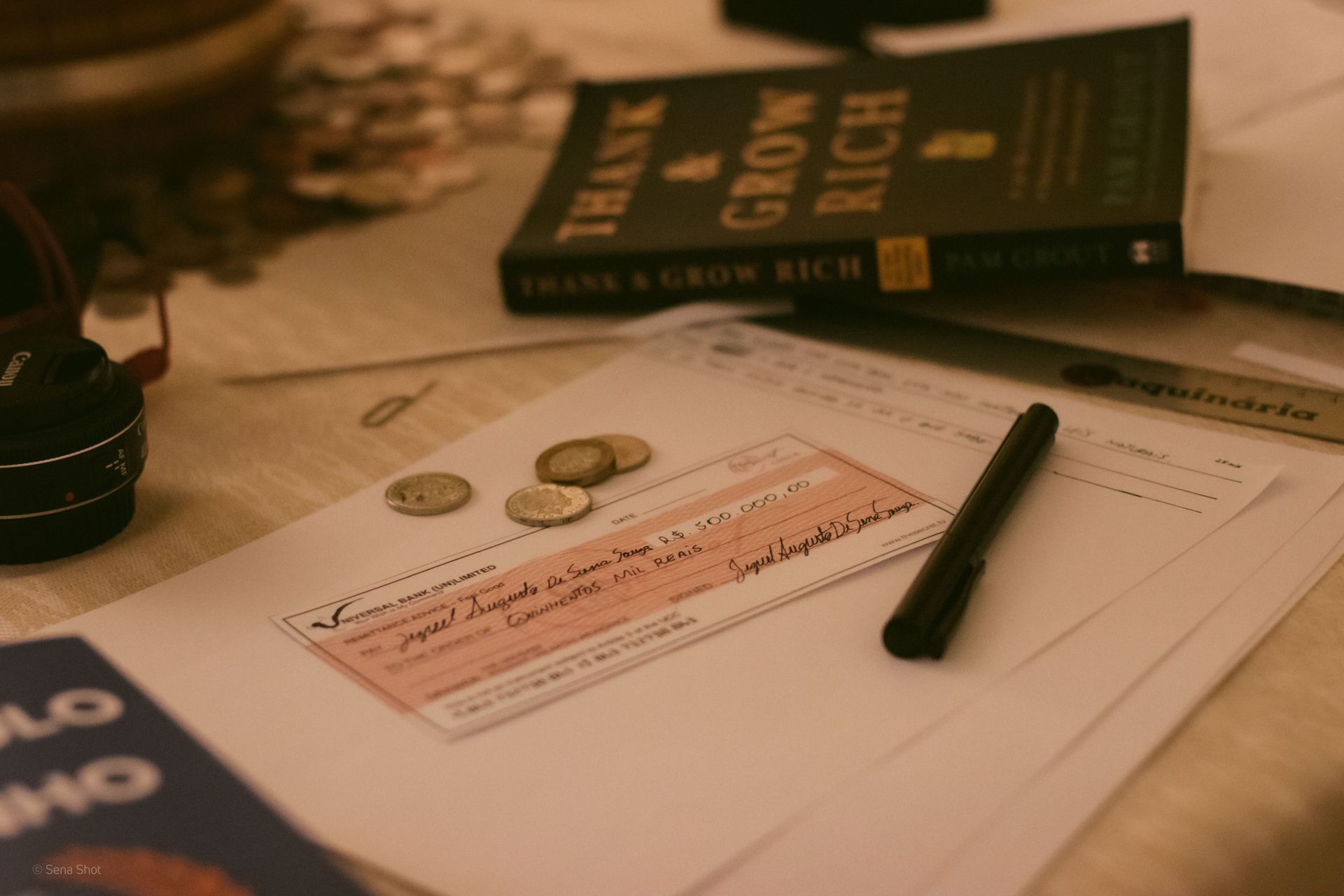 A man is sitting at a table using a calculator and writing on a clipboard.